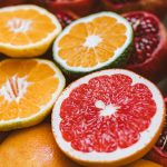Vibrant close-up of sliced citrus fruits and pomegranates showcasing freshness and variety.
