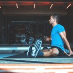 man sitting on exercise mat