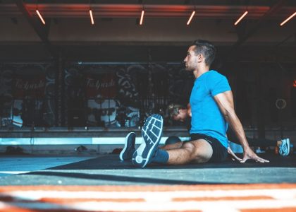 man sitting on exercise mat